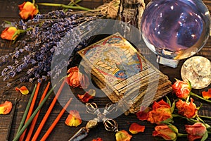 Tarot cards with magic crystal ball, candles and lavender flowers