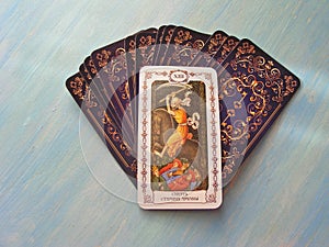 Tarot cards medieval close up with russian title Death Tarot Decks on blue wooden background