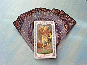 Tarot cards medieval close up with russian title The Fool Tarot Decks on blue wooden background