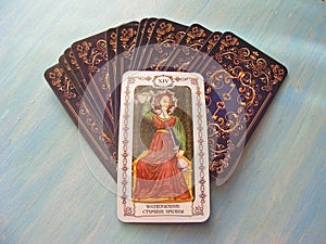 Tarot cards medieval close up with russian title Temperance, Art Tarot Decks on blue wooden background