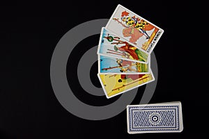 Tarot cards placed on the right of the image. Black surface