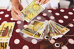 Tarot cards reading divination Psychic readings and clairvoyance concept fortune teller hands , and Horoscopes