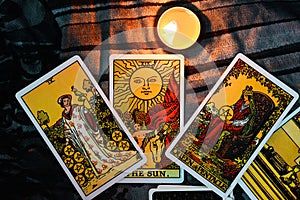 Tarot reading with tarot card background and candlelight on the table for Astrology Occult Magic Spiritual Horoscopes and Palm