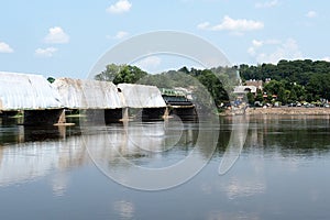 The tarp is on the bridge while it is under construction.