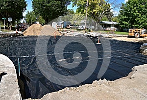 Tarpaulin spread over a street for water-proofing