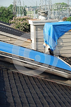 Tarpaulins on roof and chimney