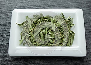 Tarragon leafs. Colorful spices in white bowls Seasonings for cooking. Natural Herbs