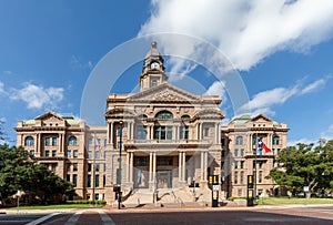 Tarrant County Courthouse in Fort Worth with the Texas flag fluttering in the wind