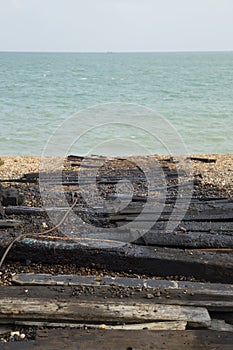 Tarred launching planks with sea background