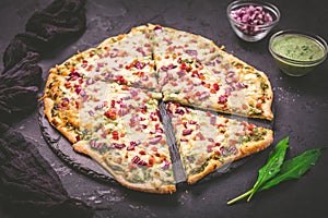 Tart flambee Flammkuchen with ramson sour cream, onion and bacon