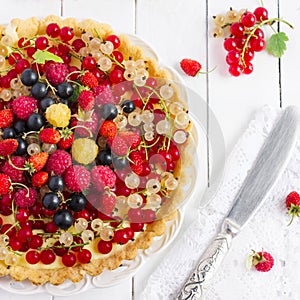 Tart with fresh berries on a white background