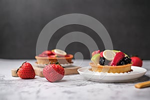 tart fruit dessert and strawberry tart with a fresh strawberry on the back background with copy space