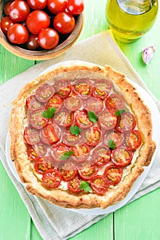 Tart with puff pastry, cheese and cherry tomatoes