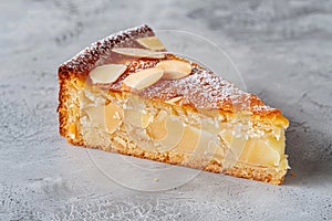 Tarta de Santiago. Traditional slice almond cake from Santiago in Spain on gray background photo