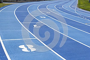 Tartan running track in blue with eight lanes