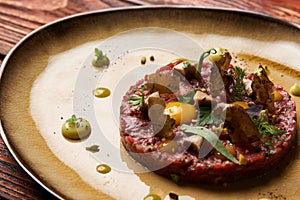 Tartare Steak with egg yolk and glass of red wine