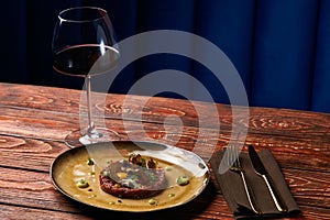 Tartare Steak with egg yolk and glass of red wine