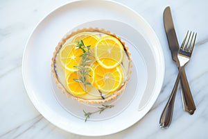 tarte au citron with a creamy swirl, candied lemon atop