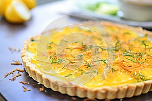 tarte au citron with lemon zest curls centered, close-up