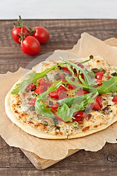 Tarte flambee, an alsatian pizza, with tomatoes and arugula