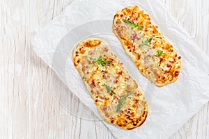 Tarte Flambee - flat bread Flammkuchen with bacon, onion, champignon and cheese