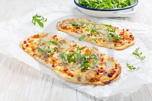 Tarte Flambee - flat bread Flammkuchen with bacon, onion, champignon and cheese