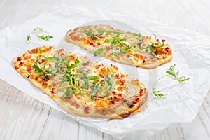 Tarte Flambee - flat bread Flammkuchen with bacon, onion, champignon and cheese