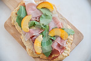 Tarte flambee with ham and arugula