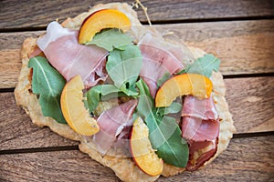 Tarte flambee with ham and arugula