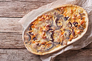 Tarte flambee on a paper. Horizontal top view