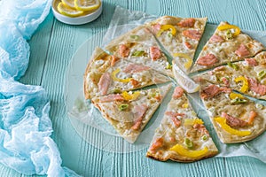 Tarte flambee with salmon, yellow pepper and spring onions