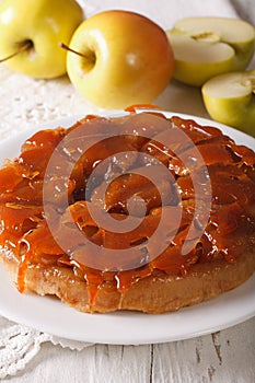 Tarte Tatin with apples and caramel close up on a plate. vertica