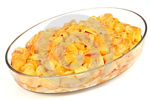 Tartiflette in a dish on a white background