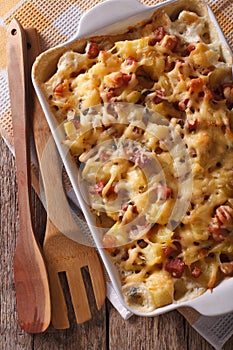 Tartiflette potatoes with bacon and cheese close up vertical top
