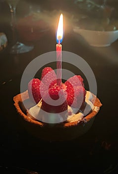 Tartlet cake with raspberries and candle