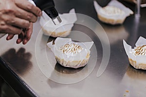 Tartlet with a meringue and kitchen torch blowtorch with blue flame. woman hand holdings blowtorch. bakery concept