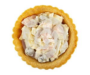 Tartlet with olivier salad isolated on white. Top view