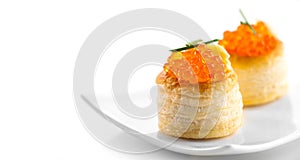 Tartlet with red caviar close up. Gourmet food closeup, appetizer. Close-up salmon caviar. Delicatessen