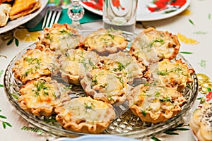 Tartlets with cheese and mushrooms on a festive table