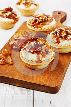 Tartlets with cream and nuts poured with caramel
