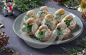 Tartlets with mushrooms, egg and cheese on a dark gray background. Delicious holiday snack.