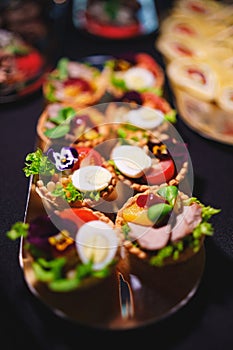 tartlets with pate and salad garnished with flowers. Delicious appetizers.