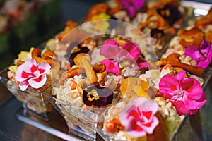 tartlets with pate and salad garnished with flowers. Delicious appetizers.