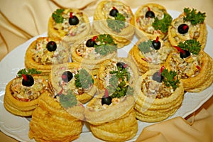 Tartlets with salad on dish. Mini quiches