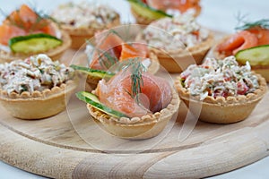 Tartlets with salmon, tuna, cheese, cucumber and dill.