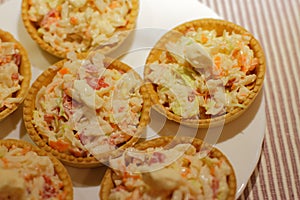 Tartlets with snack on white plate photo