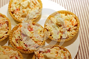 Tartlets with snack on white plate photo