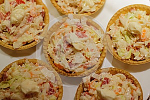 Tartlets with snack on white plate photo