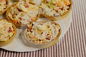 Tartlets with snack on white plate photo