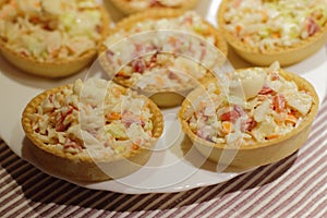 Tartlets with snack on white plate photo